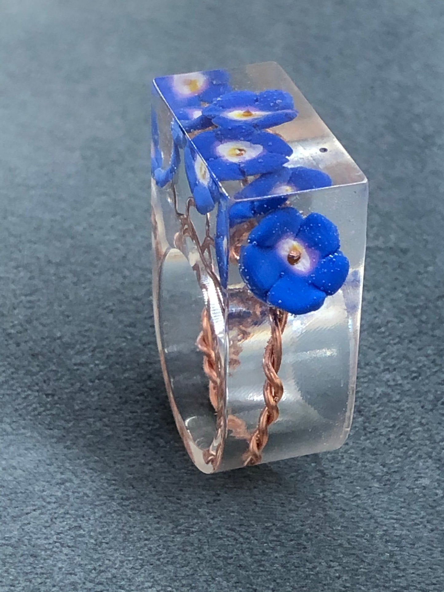 Forget me not Ring, is a handmade crystal clear epoxy resin ring with Forget me not Ring, is a handmade crystal clear epoxy resin ring with hand sculpted polymer clay forget me not flowers encased inside. Part of Padpod & Berries Wresin ringPadpod & BerrieMy Fairytale Giftshandmade crystal clear epoxy resin ring