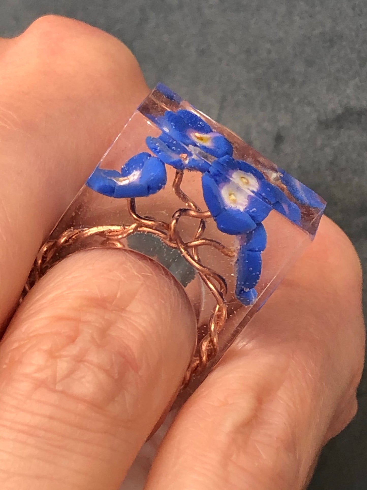 Forget me not Ring, is a handmade crystal clear epoxy resin ring with Forget me not Ring, is a handmade crystal clear epoxy resin ring with hand sculpted polymer clay forget me not flowers encased inside. Part of Padpod & Berries Wresin ringPadpod & BerrieMy Fairytale Giftshandmade crystal clear epoxy resin ring