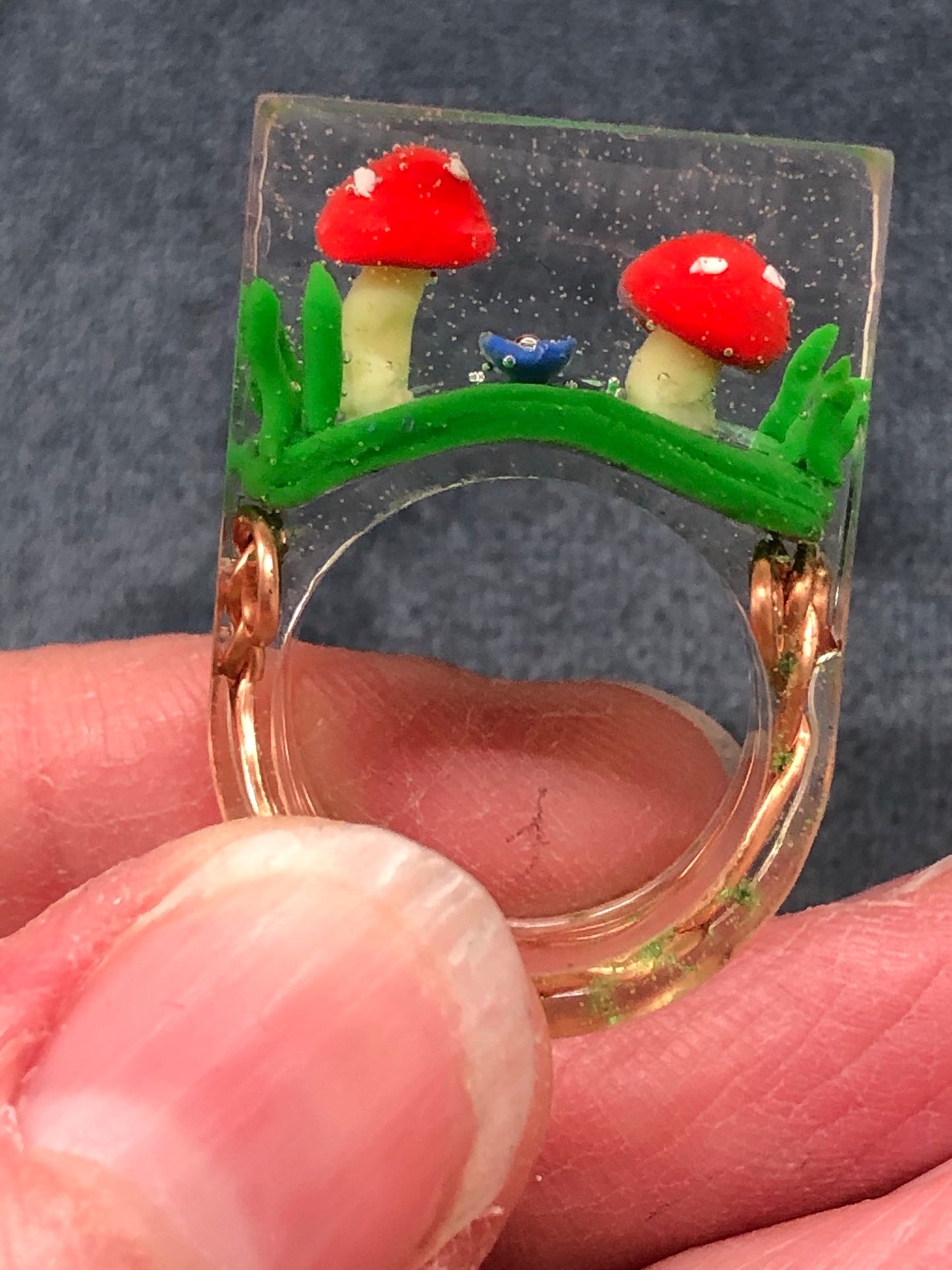 Mushroom Ring hand sculpted mushrooms and entwined copper wire encasedMushroom Ring hand sculpted mushrooms and entwined copper wire encased in hand poured epoxy resin to create this stunning piece. Part of Padpod & Berrie World inresin ringPadpodandberrieMy Fairytale GiftsMushroom Ring hand sculpted mushrooms