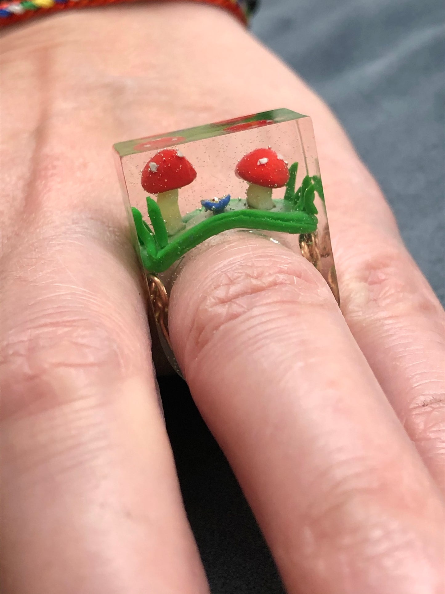 Mushroom Ring hand sculpted mushrooms and entwined copper wire encasedMushroom Ring hand sculpted mushrooms and entwined copper wire encased in hand poured epoxy resin to create this stunning piece. Part of Padpod & Berrie World inresin ringPadpodandberrieMy Fairytale GiftsMushroom Ring hand sculpted mushrooms