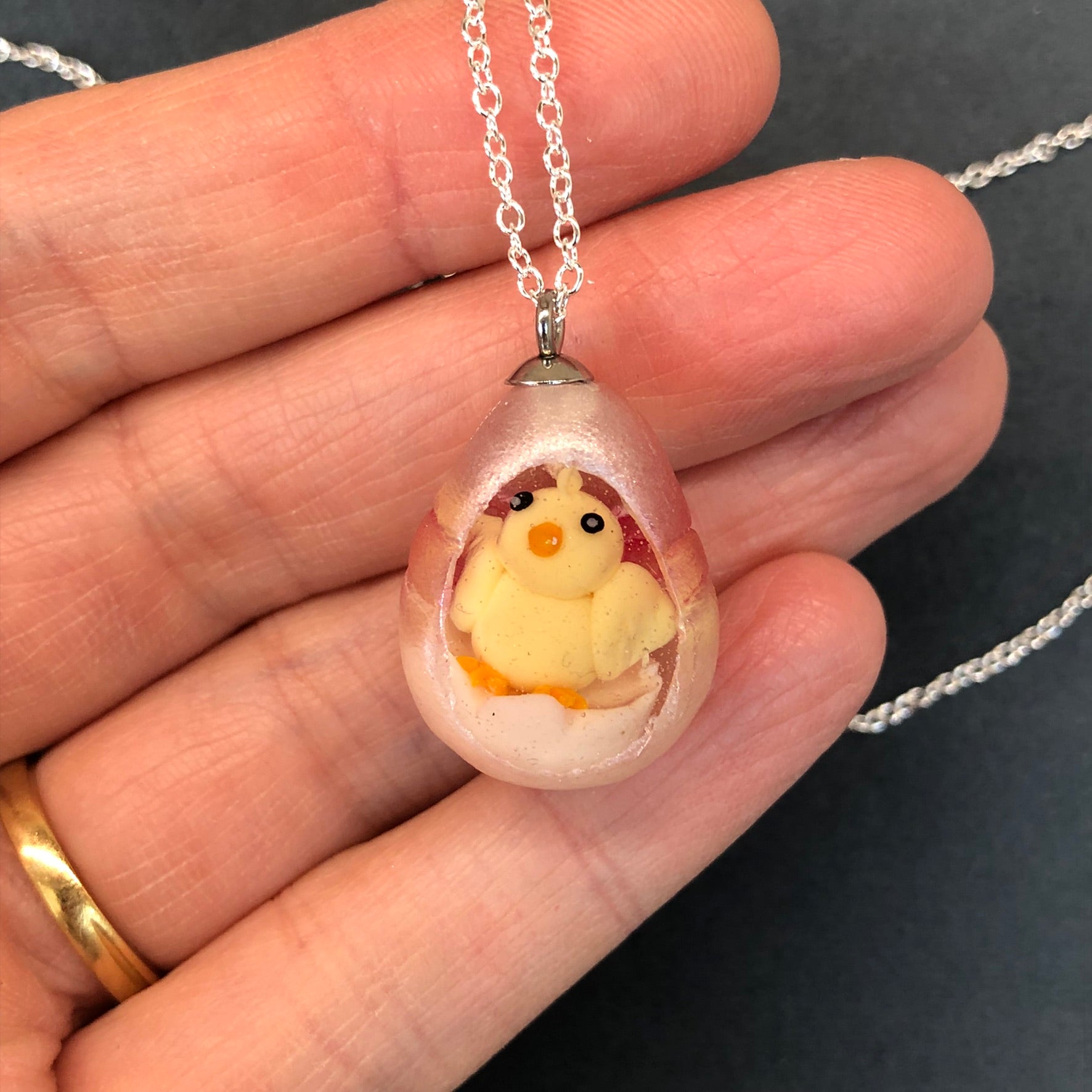 my hand sculpted polymer clay chick Secret Egg necklace Ooak jewellery, my hand sculpted polymer clay chick inside hand poured epoxy resin egg which is made from my handmade silicone mold. Secret Egg nnecklacePadpodandberrieMy Fairytale Giftshand sculpted polymer clay chick inside hand poured epoxy resin egg