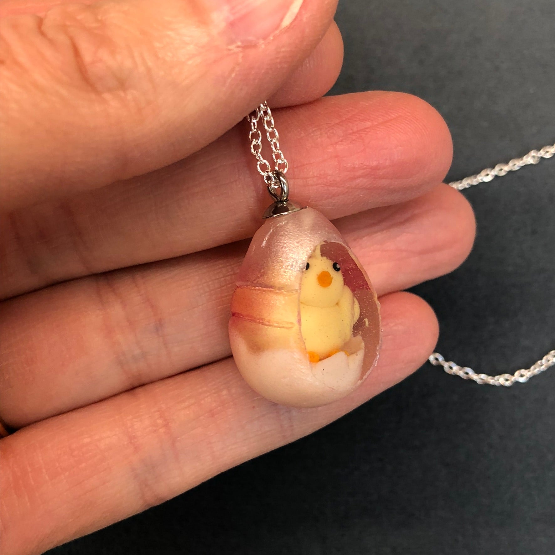 my hand sculpted polymer clay chick Secret Egg necklace Ooak jewellery, my hand sculpted polymer clay chick inside hand poured epoxy resin egg which is made from my handmade silicone mold. Secret Egg nnecklacePadpodandberrieMy Fairytale Giftshand sculpted polymer clay chick inside hand poured epoxy resin egg